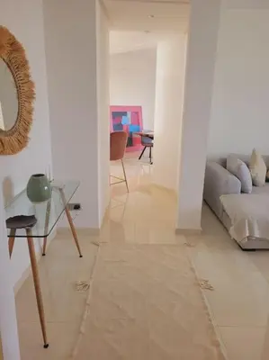 a living room with a couch and a table at Luxury in the heart of Hay Riad in Rabat