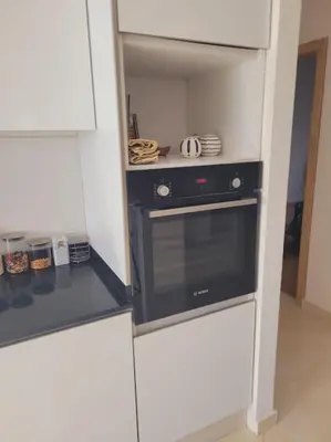 a kitchen with a black oven and a pantry at Luxury in the heart of Hay Riad in Rabat