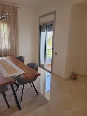 a dining room with a wooden table and chairs at Luxury in the heart of Hay Riad in Rabat
