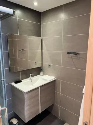 a bathroom with a sink and a mirror at Superbe appartement avec piscine in Rabat