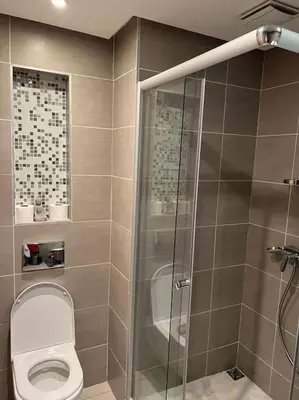 a bathroom with a shower and a toilet at Superbe appartement avec piscine in Rabat