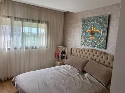 a bedroom with a large bed and a window at Superbe appartement avec piscine in Rabat