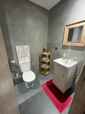 a bathroom with a white toilet and a sink at Superbe Appartement Bouskoura in Bouskoura