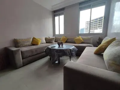 a living room with a couch and a table at Appartement Casablanca Anfa in Casablanca
