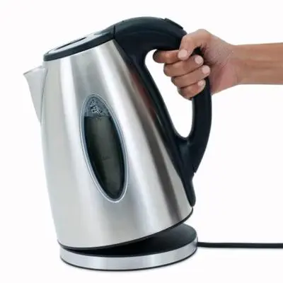 a hand is holding a tea kettle at Appartement Casablanca Anfa in Casablanca