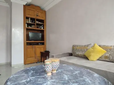 a living room with a couch and a table at Appartement Casablanca Anfa in Casablanca