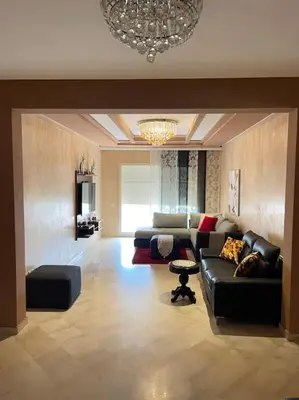 a living room with a couch and a chandelier at Big luxury apartment near airport in Nouaceur