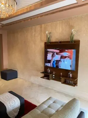 a living room with a flat screen tv on a wall at Big luxury apartment near airport in Nouaceur