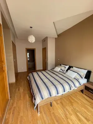 a bedroom with a large bed in a room at Big luxury apartment near airport in Nouaceur