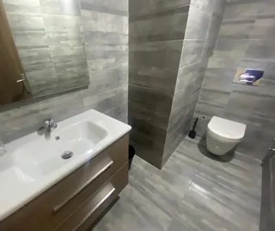 a bathroom with a sink and a toilet at Luxueux appartement avec vue panoramique WELCOME STAY in Mohammedia