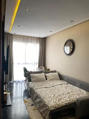 a bedroom with a bed and a clock on the wall at Appartement Cosy et chaleureux - Casablanca centre in Casablanca
