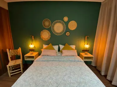 a bedroom with a bed with a green wall at Appartement Cosy et chaleureux - Casablanca centre in Casablanca