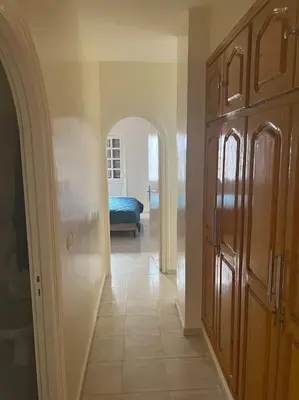 a room with a hallway with a bed and an archway at Au centre de Agdal in Rabat
