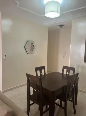 a dining room table and chairs in a room at Au centre de Agdal in Rabat