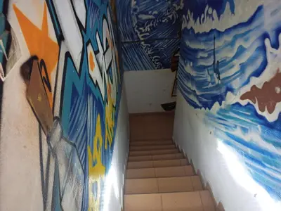 a hallway with graffiti on the walls of a bathroom at Booking and hosting medina in Casablanca