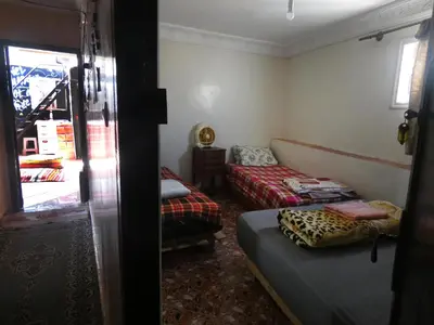 a small room with two beds and a window at Booking and hosting medina in Casablanca