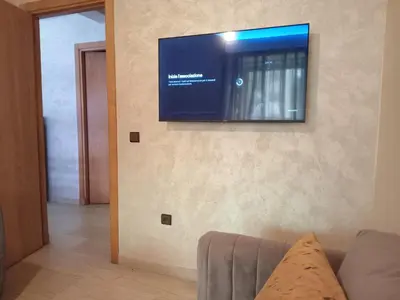 a flat screen tv on the wall of a living room at 3 Bedroom Apartment with Wifi in Casablanca