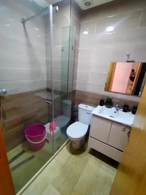 a bathroom with a shower and a toilet and a sink at 3 Bedroom Apartment with Wifi in Casablanca