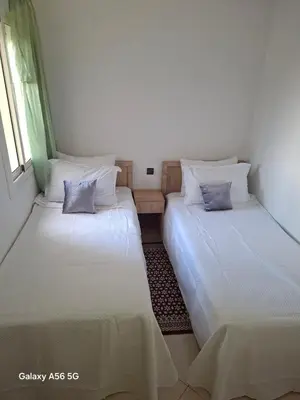 two beds in a room with white sheets and pillows at Appartement Fasthôtel Casablanca in Casablanca