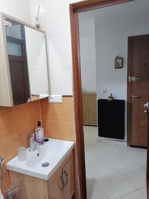 a bathroom with a sink and a mirror at Appartement Fasthôtel Casablanca in Casablanca