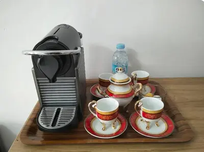 a wooden tray with tea cups and a coffee maker at Appartement Fasthôtel Casablanca in Casablanca