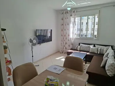 a living room with a couch and a table at Appartement Fasthôtel Casablanca in Casablanca
