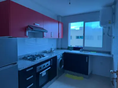 a kitchen with purple cabinets and a stove top oven at Appt front la mer in Rabat