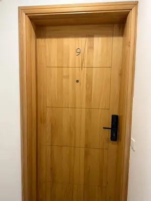 a wooden door with a phone on top of it at Appt front la mer in Rabat