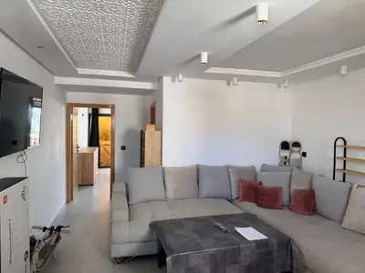 a living room with a couch and a coffee table at Appt 1 ch salon for saison in Rabat