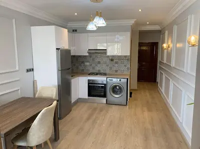 a kitchen with a table and a stove and a dishwasher at Chic & Cozy Studio Centre Ville Super Propre in Casablanca
