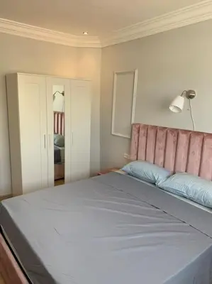 a bedroom with a large bed with a pink headboard at Chic & Cozy Studio Centre Ville Super Propre in Casablanca
