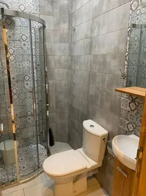 a bathroom with a shower and a toilet and a sink at Chic & Cozy Studio Centre Ville Super Propre in Casablanca