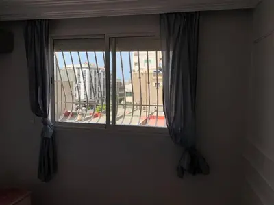a window with curtains and a view of a city at Chic & Cozy Studio Centre Ville Super Propre in Casablanca