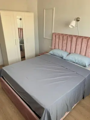 a bedroom with a large bed with a pink headboard at Chic & Cozy Studio Centre Ville Super Propre in Casablanca