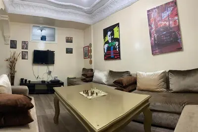 a living room with a couch and a table at Appt Tranquile et Propre Cozy a petit prix in Casablanca
