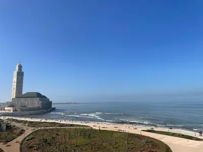 a beach with a lighthouse and the ocean at Marina Casa Del Mar - Amazing Sea & Mosque views in Casablanca