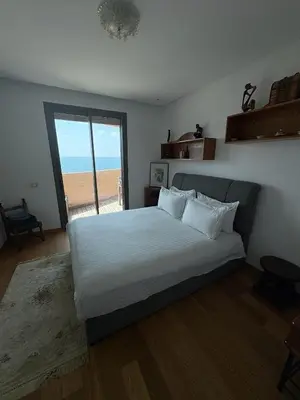 a bedroom with a bed with a view of the beach at Marina Casa Del Mar - Amazing Sea & Mosque views in Casablanca