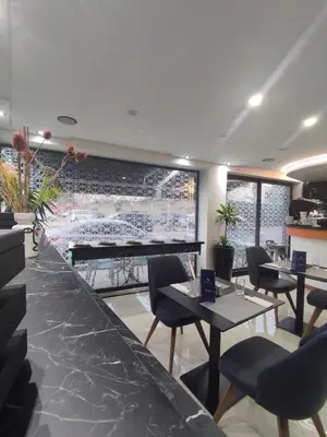 a restaurant with tables and chairs and a view of a baseball game at LOTUS HOTEL Casanearshore in Casablanca
