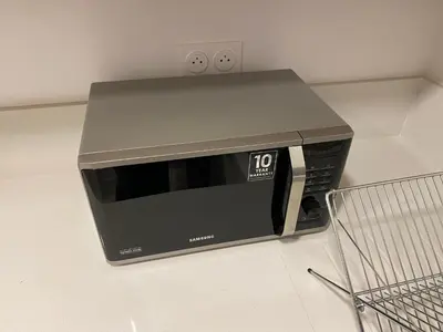 a microwave sitting on a counter next to a shopping cart at La casa in Casablanca