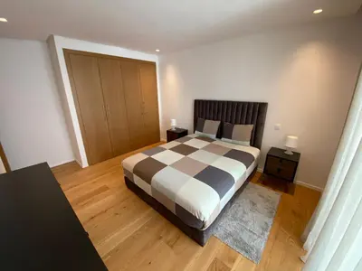 a bedroom with a large bed and wooden floors at La casa in Casablanca
