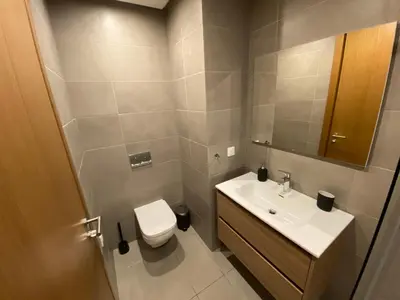 a bathroom with a sink and a toilet and a mirror at La casa in Casablanca