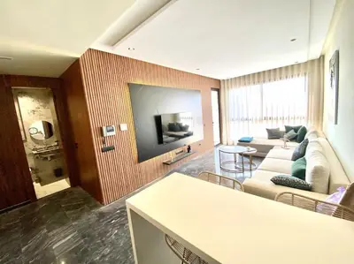 a living room with a couch and a flat screen tv at NEW modern 1 BR, 1min fr tramway in Casablanca