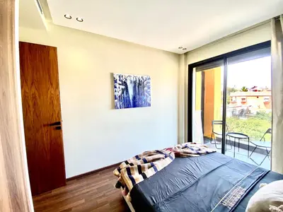 a bedroom with a bed and a large window at NEW modern 1 BR, 1min fr tramway in Casablanca