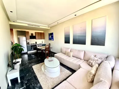 a living room with a couch and a table at NEW modern 1 BR, 1min fr tramway in Casablanca