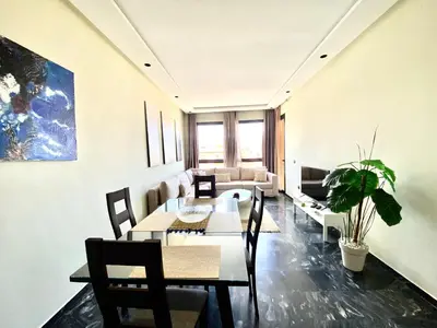 a living room with a table and chairs and a couch at NEW modern 1 BR, 1min fr tramway in Casablanca