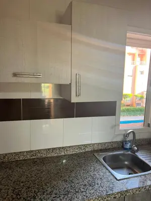 a kitchen counter with a sink and a window at Ricoflores PALM in O Ben Slimane