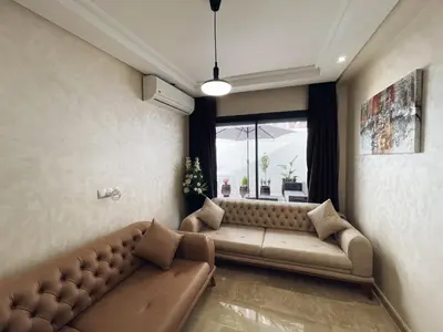 a living room with a couch and a window at High Standing & cozy apartment in central Casablanca in Casablanca