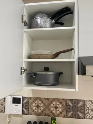 a cupboard with a pot and pans in it at High Standing & cozy apartment in central Casablanca in Casablanca