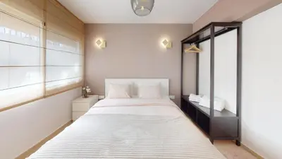a bedroom with a large white bed and a window at My Cosy Place Rabat - Studio Agdal 50m Arribat Center in Rabat