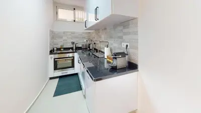 a kitchen with white appliances and a counter top at My Cosy Place Rabat - Studio Agdal 50m Arribat Center in Rabat